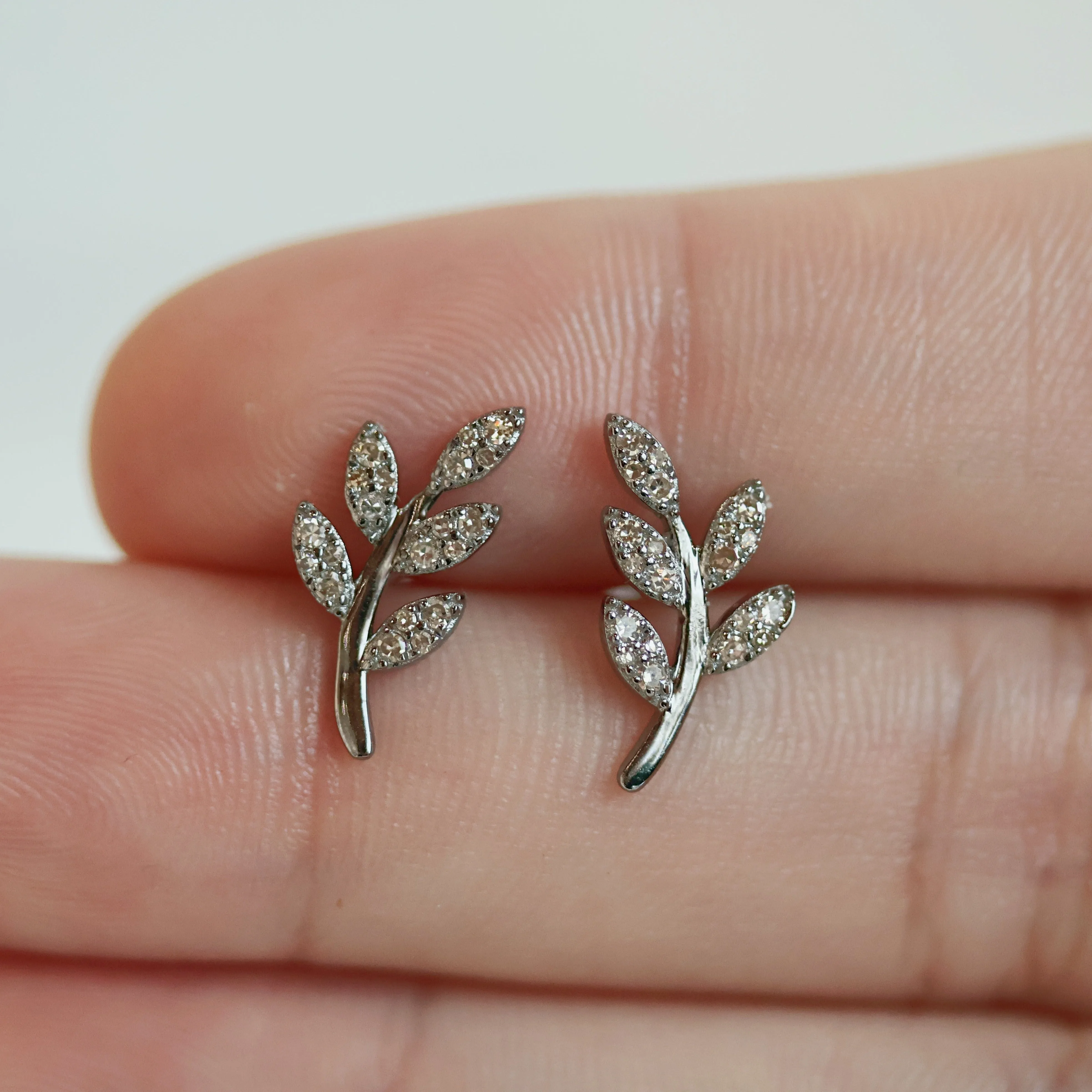 Sterling silver leaf stud earrings with diamond accents